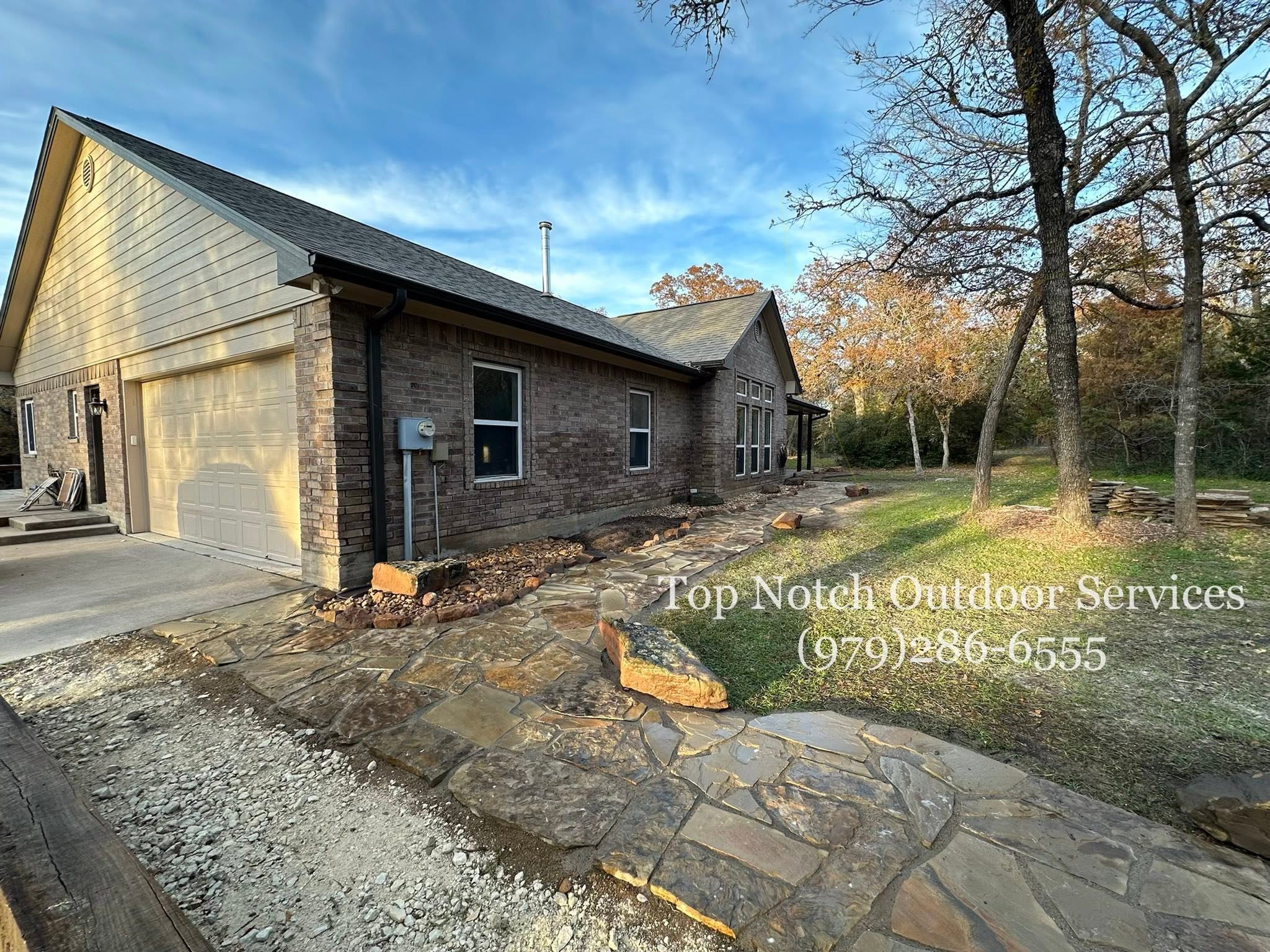 Completed flagstone walkway under a blue sky
